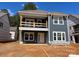 New two-story home featuring white trim and a balcony is under construction in this exterior elevation at 4033 Grommet Ct, Matthews, NC 28105