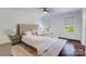 Elegant bedroom with a tufted headboard, hardwood floors, and soft, inviting textures at 4038 Zilker Park Dr, Charlotte, NC 28217