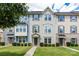 Attractive townhouse showcasing a manicured lawn and inviting entrance with muted colors and natural light at 4038 Zilker Park Dr, Charlotte, NC 28217