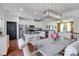 Open kitchen featuring white cabinets, granite countertops, stainless steel appliances, and a dining area at 4038 Zilker Park Dr, Charlotte, NC 28217