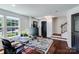 Home office showcasing dark wood floors, modern desk, and plenty of natural light and a staircase at 4038 Zilker Park Dr, Charlotte, NC 28217