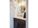 Stylish powder room featuring modern fixtures, floral wallpaper, and a sleek vanity with gold accents at 4038 Zilker Park Dr, Charlotte, NC 28217
