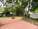 Backyard brick patio with a view of the lush lawn and a storage shed at 4315 Chandworth Rd, Charlotte, NC 28210