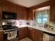 Well-equipped kitchen featuring stainless steel appliances, white countertops, and wood cabinetry at 4315 Chandworth Rd, Charlotte, NC 28210