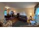 Spacious living room with hardwood floors, a striped sofa, and vintage furnishings at 4315 Chandworth Rd, Charlotte, NC 28210