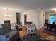Bright living space featuring hardwood floors, a floral chair, and staircase access at 4315 Chandworth Rd, Charlotte, NC 28210