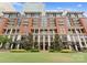 Stately apartment building with elegant brick facade and manicured landscaping enhancing its curb appeal at 435 S Tryon St # 601, Charlotte, NC 28202