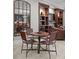 Cozy dining area featuring a round table, four chairs, and a large mirror reflecting the adjacent kitchen at 435 S Tryon St # 601, Charlotte, NC 28202
