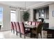 Dining room featuring a large dining table with red upholstered chairs, a modern chandelier, and a built-in hutch at 435 S Tryon St # 601, Charlotte, NC 28202