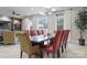 Dining room showcases a large dining table, multiple upholstered chairs, and view into an open living space at 435 S Tryon St # 601, Charlotte, NC 28202