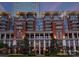 Beautiful condo building exterior with brick facade, balconies, columns and manicured landscaping at 435 S Tryon St # 601, Charlotte, NC 28202