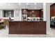 Modern kitchen with dark wood cabinets, granite countertops, and a center island at 435 S Tryon St # 601, Charlotte, NC 28202