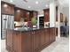 Kitchen features a large island with seating, granite countertops, stainless steel appliances, and custom wood cabinetry at 435 S Tryon St # 601, Charlotte, NC 28202