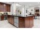 Kitchen island boasts a dark countertop, stainless steel dishwasher, drawers, and cabinets, with a breakfast table nearby at 435 S Tryon St # 601, Charlotte, NC 28202