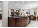 Kitchen island with a dark countertop, sink, stainless steel dishwasher, and an open view into the dining and living areas at 435 S Tryon St # 601, Charlotte, NC 28202