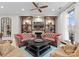 Comfortable living room featuring leather sofas, built-in shelving, and a ceiling fan at 435 S Tryon St # 601, Charlotte, NC 28202