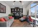 Comfortable living room with large windows, hardwood floors, and a built-in bookcase at 435 S Tryon St # 601, Charlotte, NC 28202