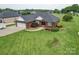 Spacious red brick home with an attached garage, lush green lawn, and well-maintained landscaping at 4618 Dallas High Shoals Hwy, Dallas, NC 28034