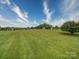 Expansive backyard with well-maintained lawn and view of the community at 4618 Dallas High Shoals Hwy, Dallas, NC 28034