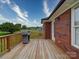 A spacious wooden deck featuring a grill, perfect for outdoor gatherings and relaxation at 4618 Dallas High Shoals Hwy, Dallas, NC 28034