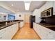 Bright, galley-style kitchen with white cabinets, sleek countertops, and stainless steel appliances at 4618 Dallas High Shoals Hwy, Dallas, NC 28034