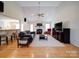 Bright living room featuring high ceilings, a fireplace, modern furnishings, and wood flooring at 4618 Dallas High Shoals Hwy, Dallas, NC 28034