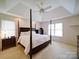 Bedroom with neutral walls, a decorative ceiling, and four-poster bed at 4618 Dallas High Shoals Hwy, Dallas, NC 28034