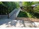 Inviting backyard with stairs leading to the home, a deck area and scenic nature views at 46827 Tall Whit Rd, New London, NC 28127