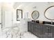 Bright bathroom featuring double sink vanity, round mirrors, and marble floors for a spa-like experience at 46827 Tall Whit Rd, New London, NC 28127