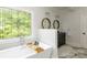 Bright bathroom with soaking tub, stain glass window, and double vanity creating a relaxing space at 46827 Tall Whit Rd, New London, NC 28127