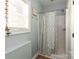 Compact bathroom with neutral tones, shower with curtain, and natural light creating a functional space at 46827 Tall Whit Rd, New London, NC 28127