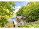 Charming boat house with wooded surroundings and stairs leading down to the lake at 46827 Tall Whit Rd, New London, NC 28127