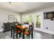 Cozy dining area with a table for four and access to an outdoor area through glass doors at 46827 Tall Whit Rd, New London, NC 28127