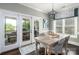Elegant dining area with a chandelier, stylish window treatments, and access to the outdoor space at 46827 Tall Whit Rd, New London, NC 28127