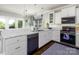 Modern kitchen with white countertops, stainless steel appliances, and views of the outdoor deck at 46827 Tall Whit Rd, New London, NC 28127