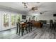 Spacious living room with hardwood floors, ceiling fans, and access to the outdoor patio at 46827 Tall Whit Rd, New London, NC 28127