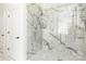 Luxurious marble shower with glass enclosure and chrome fixtures offering a modern design at 46827 Tall Whit Rd, New London, NC 28127