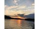Picturesque sunset over the calm lake waters, reflecting warm colors and peaceful scenery at 46827 Tall Whit Rd, New London, NC 28127