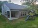 Backyard view of home featuring a covered patio and playset at 5031 Burnwald Ct, Fort Mill, SC 29715