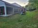 Large backyard with patio, wooden playset, and fence, offering ample space for leisure and recreation at 5031 Burnwald Ct, Fort Mill, SC 29715