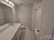 Bathroom with white vanity, large mirror, shower with tub, and tile flooring at 5031 Burnwald Ct, Fort Mill, SC 29715