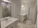 Bathroom featuring dual sink vanities and a tiled walk-in shower with glass doors at 5031 Burnwald Ct, Fort Mill, SC 29715