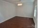 Well-lit bedroom featuring hardwood floors, ample natural light, and a modern chandelier at 5031 Burnwald Ct, Fort Mill, SC 29715