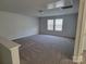 Spacious bonus room with neutral carpet, natural light and two windows at 5031 Burnwald Ct, Fort Mill, SC 29715