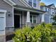 Inviting covered front porch with decorative stone accents and lush landscaping at 5031 Burnwald Ct, Fort Mill, SC 29715