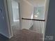Upstairs landing with railing, window, and a view into the bedrooms at 5031 Burnwald Ct, Fort Mill, SC 29715