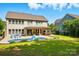 Expansive backyard featuring a pool, lounge chairs, covered patio, and outdoor kitchen area, perfect for entertaining at 5105 Paisano Ln, Waxhaw, NC 28173