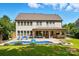 Spacious backyard featuring a pool, outdoor seating, covered patio, and lush green lawn, ideal for outdoor activities at 5105 Paisano Ln, Waxhaw, NC 28173