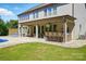 Charming backyard with a covered patio, outdoor bar, swimming pool, and lush green lawn for outdoor entertaining at 5105 Paisano Ln, Waxhaw, NC 28173