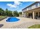 Stunning backyard featuring a pool, lounge chairs, a covered patio, and lush landscaping at 5105 Paisano Ln, Waxhaw, NC 28173
